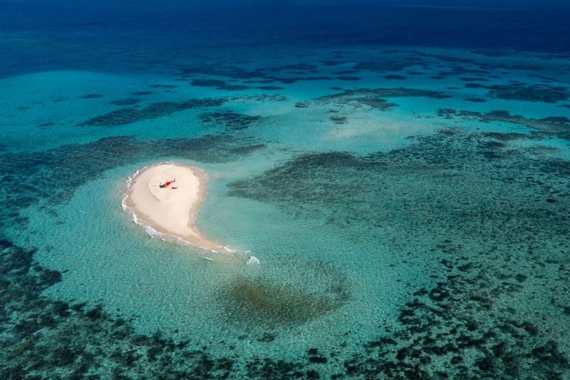 Helicopter landing on Vlasoff Cay in the Great Barrier Reef, Queensland, Australia