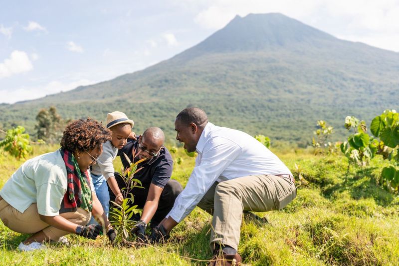 family planting a tree in Rwanda