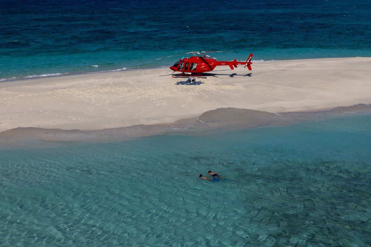 Helicopter landing on a private cay in the Great Barrier Reef in Australia