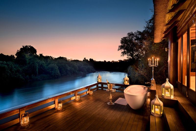 AF Zambia Royal Chundu Island Lodge deck dusk for Soak in Style: Outdoor Bathtubs Are the Ultimate Luxury Escape