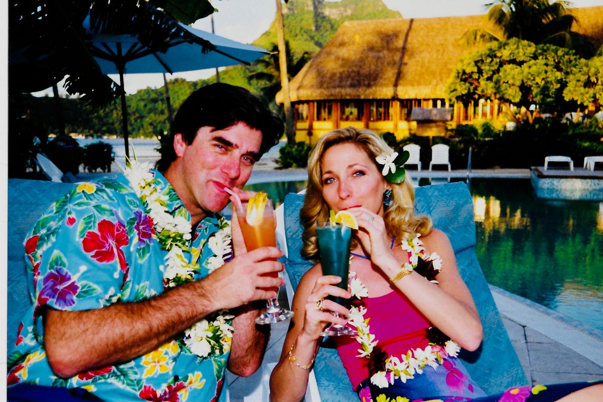 Linda and Ian Swain sip cocktails on their first couple's trip to Tahiti.