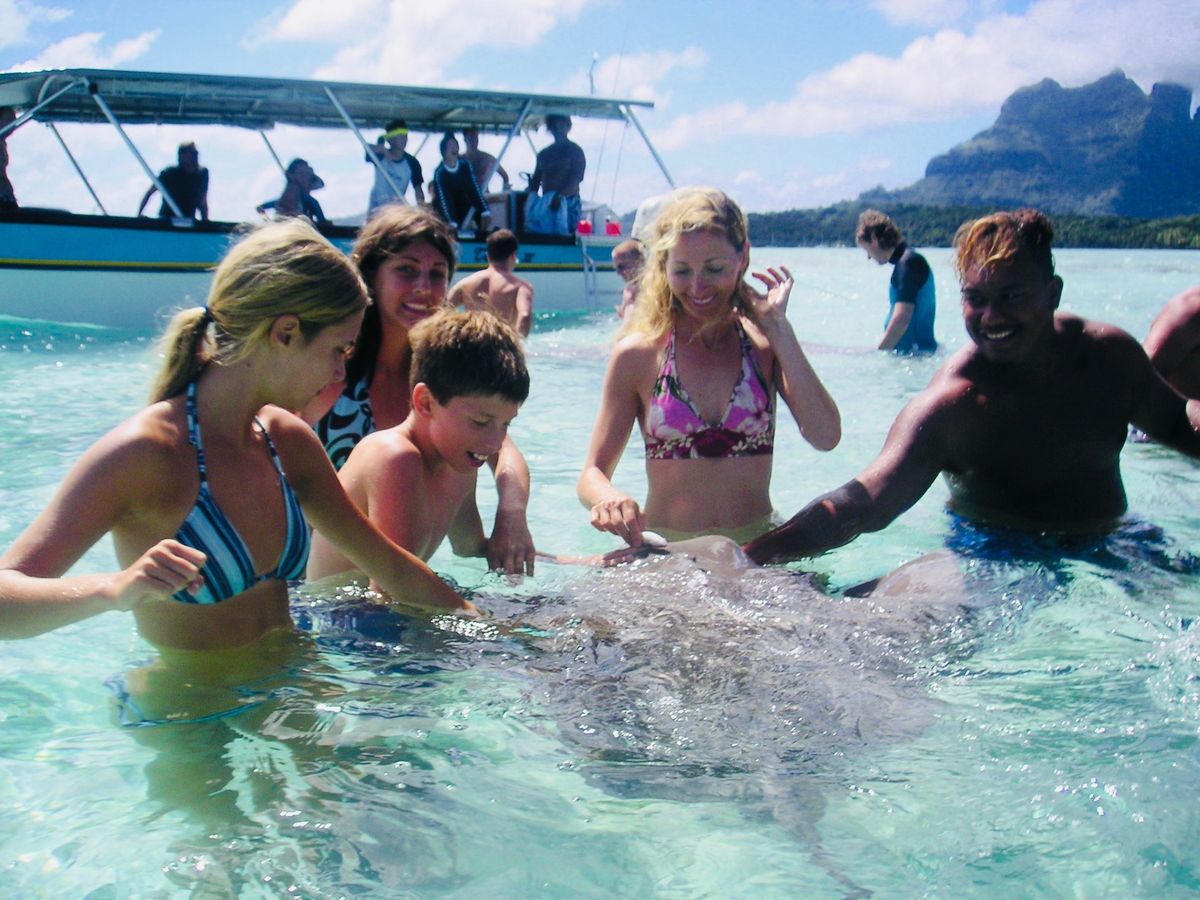The Swain family swimming with stingrays in Tahiti.