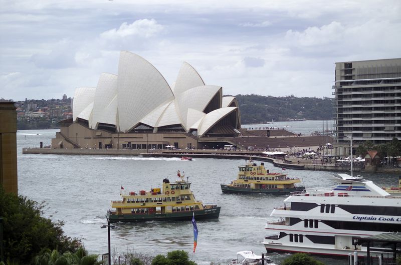 Long shot of Circular Quay with Captain Cook Cruise and Sydney Ferry in harbour, and the Opera House in background, Sydney | Photo Credit: Destination NSW; Sally Mayman