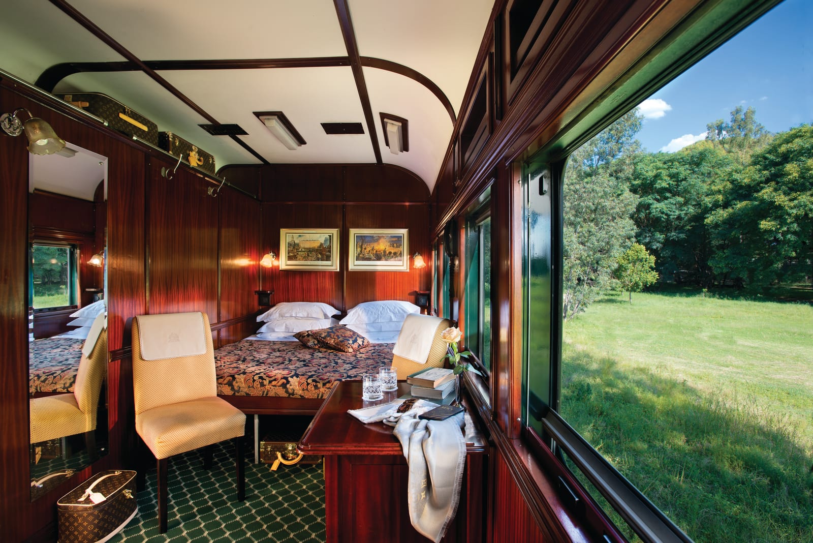 Deluxe Suite with a double bed and picture window aboard Rovos Rail