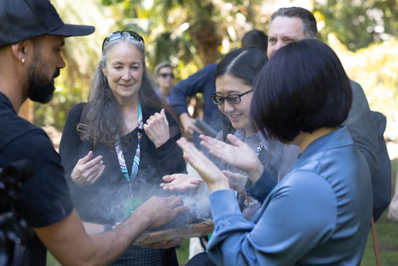 Visitors taking part in a smoking ceremony in Adelaide