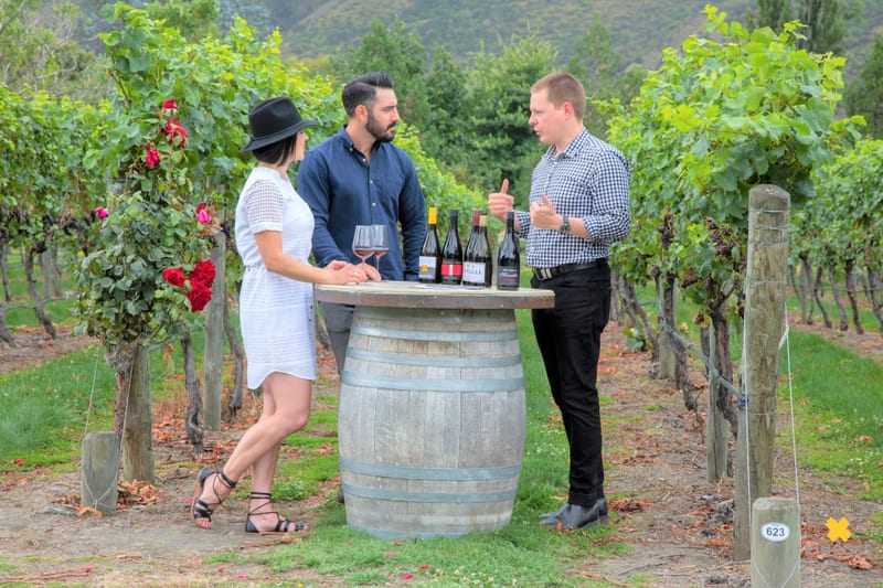 Couple wine tasting outdoors in Central Otago